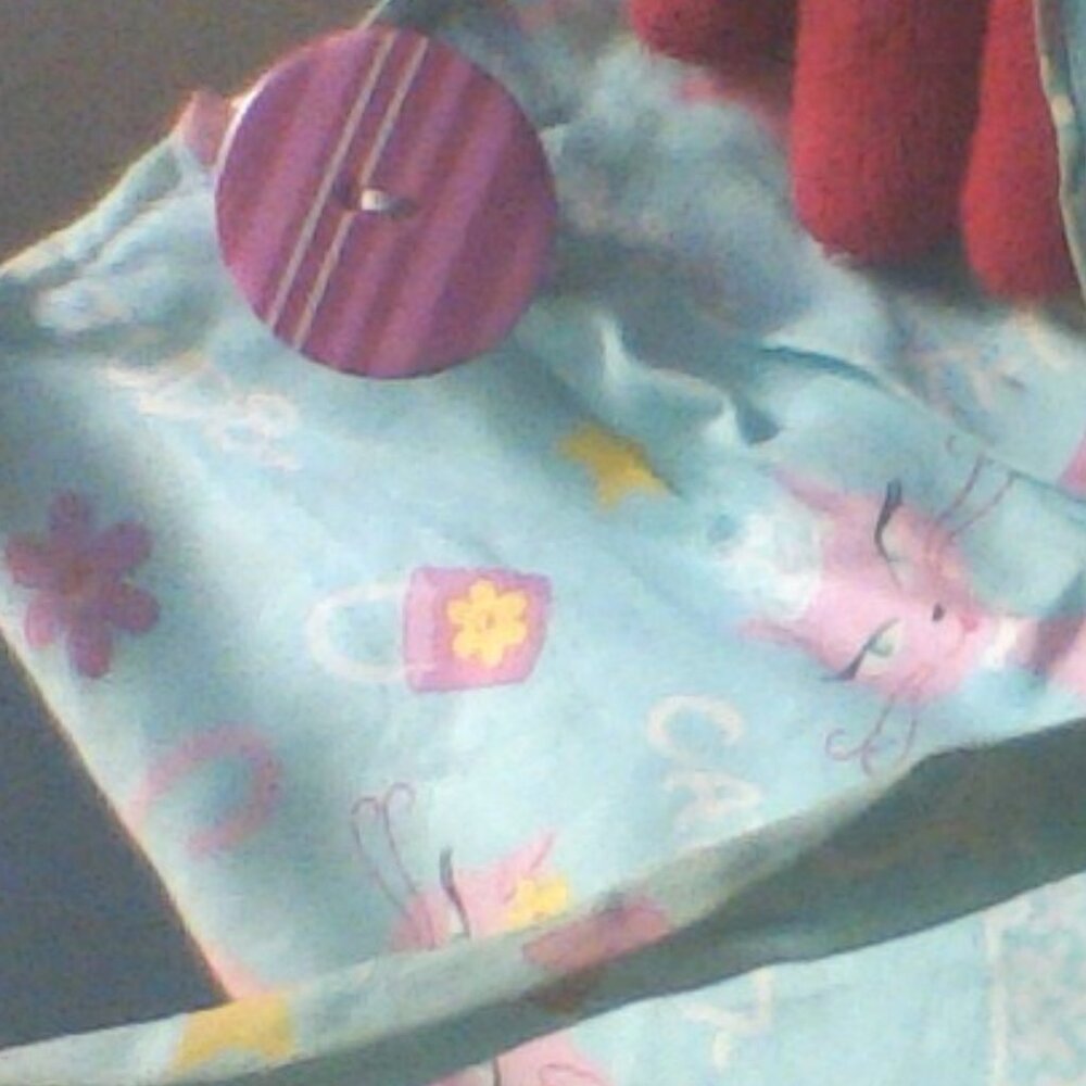 Hand crafted cute bag with a big pink button no info.